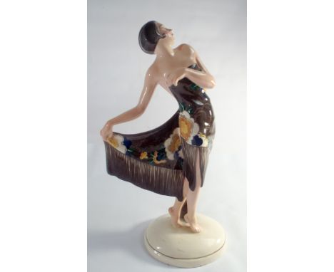 A Goldscheider Pottery model of a dancer designed by Josef Lorenzl, model no.6345, the lady dressed in a art deco brown dress
