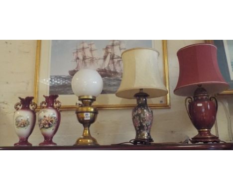 Two oriental style table lamps with shades, a brass oil lamp and a pair of figure decorated vases 