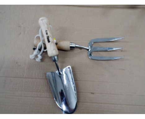 A stainless steel hand trowel and hand fork