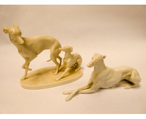 Nymphenburg blanc de chine group of two whippets and a similar porcelain model of a recumbent greyhound. 19cm across, 15cm hi
