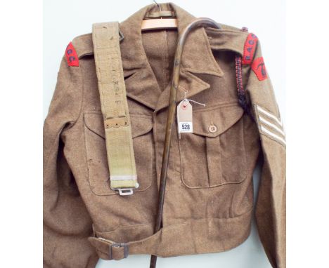 An original war time sergeants tunic together with walking stick, military belt and other items of military clothing  