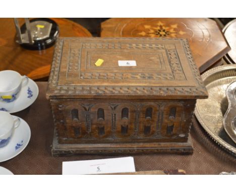 A table topped wooden trinket box with carved decoration