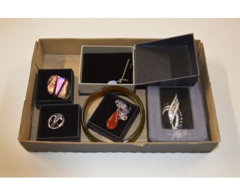 A box of various costume jewellery to include a jade type bangle, pendants, brooches etc.