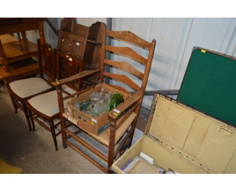 An oak ladder back and rush seated carver chair