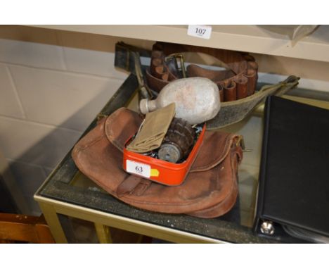 A brown leather cartridge belt; a cartridge bag; and a tin containing a grenade (de-activated); military buttons; a whistle; 