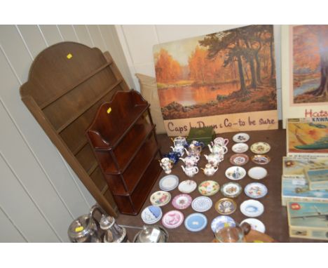 A collection of miniature cabinet plates and teapots to include Royal Copenhagen, Lladro etc.both with wooden racks 