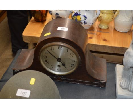 An oak cased three hole mantel clock