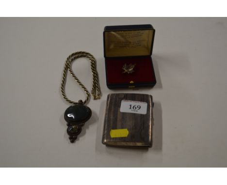 An Art Deco design silver cigarette case; and a agate white and yellow metal pendant; and a leaf brooch