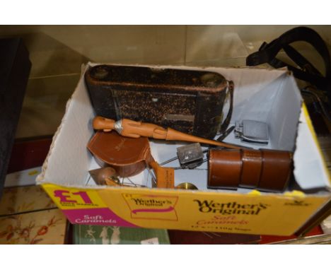A box containing a Kodak folding camera; a carved hardwood letter opener; a brown leather stud box; a Ronson lighter etc.