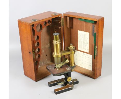 An Edwardian mahogany cased brass and iron microscope serial number 19786.