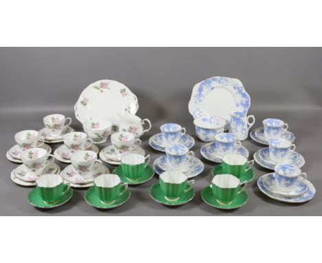 A Duchess six place tea service decorated with roses along with a similar blue and white example and six green glazed cups an