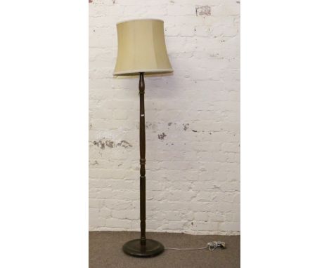 A turned oak standard lamp.