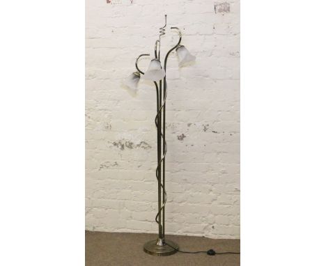 A three branch brushed brass standard lamp with milchglas shade.