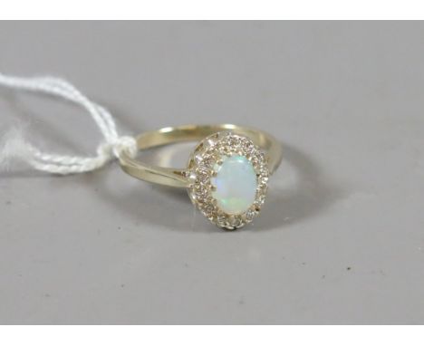 A 9ct gold opal and diamond cluster ring, size M 1/2.