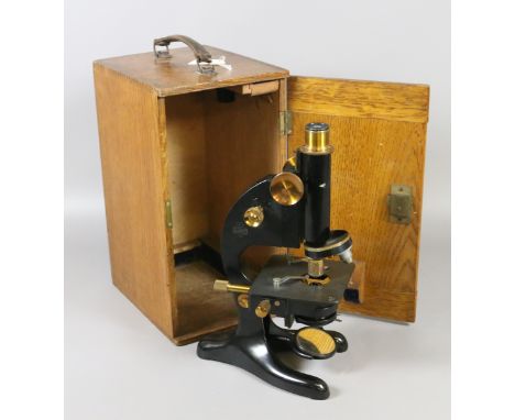 An oak cased microscope model 29 by R & J Beck Ltd London.