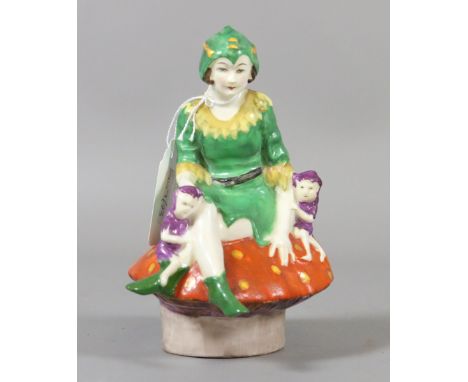 A Crown Staffordshire china figure group in the manner of Mabel Lucie Atwell formed as a pixie and two imps seated on a toad 