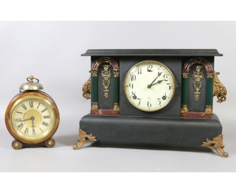 An ebonized eight day mantel clock raised on splayed supports along with a circular alarm clock.