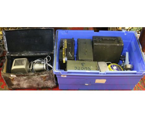 A cased Aldis projector along with a collection of camping stoves to include military examples.