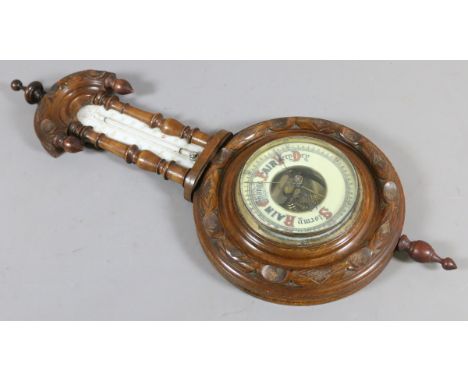 A barometer in carved walnut case incorporating a thermometer.