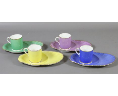 A set of four Copeland coloured china teacups and biscuit saucers with gilt decoration.
