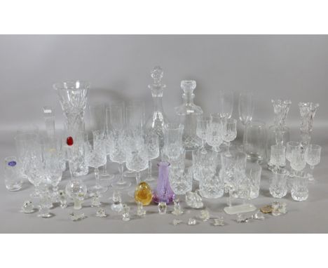 A large collection of cut glass items to include lead crystal decanter along with Swarovski ornaments and Caithness examples.