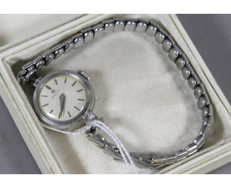 A ladies 1970s Omega manual bracelet watch in stainless steel case with pointed hands and applied gilt baton markers, Cal.244