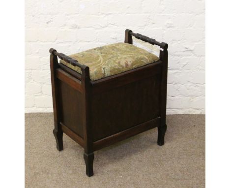 A mahogany upholstered piano stool raised on tapering supports.