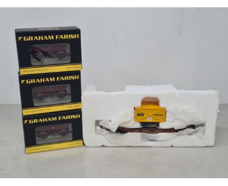 Three boxed Graham Farish N gauge EWS Hopper Wagons and a Hornby 00 gauge Low-loader Wagon 