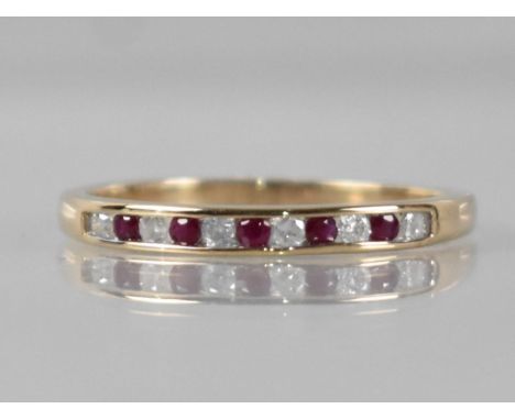 A 9ct Gold, Diamond and Ruby Ring, Eleven Channel Set Round Cut Stones Comprising Six Diamonds (Totalling 0.14ct) and Five Ru