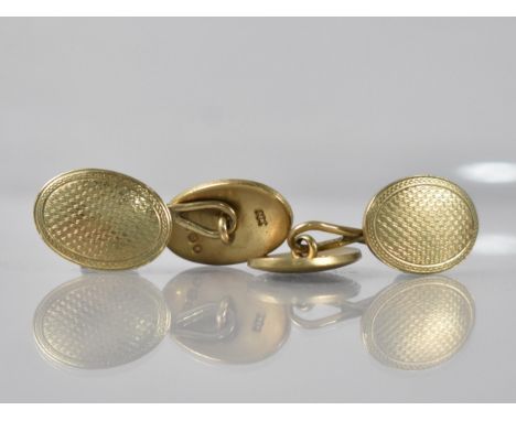 A Pair of 9ct Gold Cufflinks, Oval Domed Panels 18.3mm by 13.2mm with Engine Turned Engraved Decoration having Figure of Eigh