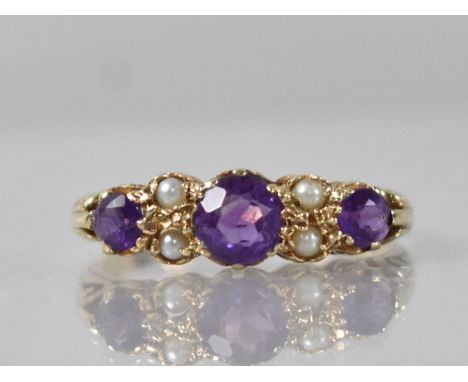 A Vintage Amethyst and Seed Pearl Ladies Boat Style Ring, Central Round Cut Stone Measuring 5.5mm Diameter, Claw and Tension 