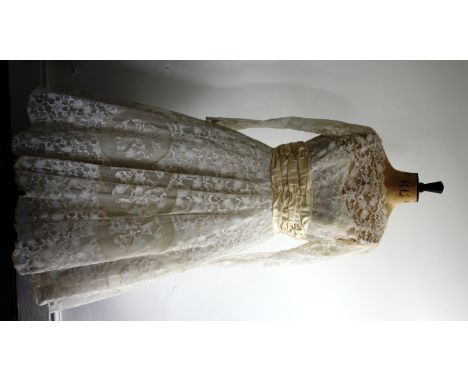 1950s wedding dress. Features full lace body and skirt, full skirt with net underskirt and satin waist sash and bow. Slight s