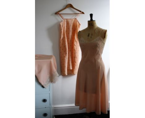 A trio of 1940s slips. A waist slip in soft pink rayon with lace trim, waist 30 inches. Side seem requires repair. A silk ful