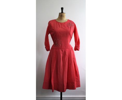 1950s coral pink grosgrain cocktail dress with embroidery, diamante and pearl design on the front, back belt and box pleated 