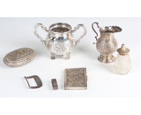 A late Victorian silver baluster cream jug, embossed with flowers and scrolls, on a circular stepped foot, Chester 1896 by Ge