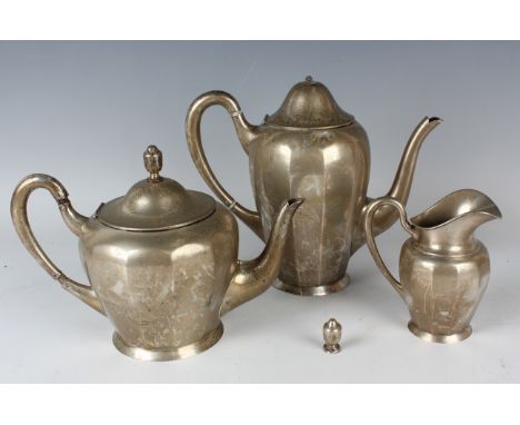 A German .800 silver three-piece tea set of ovoid faceted form, comprising teapot, hot water pot and milk jug, total weight 1