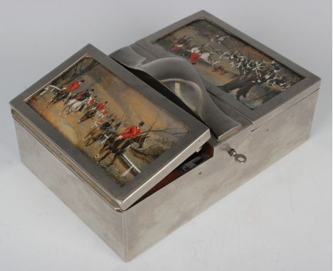 An early 20th century plated twin hinged lidded rectangular cigar box with central handle, each hinged lid glazed with a Geor