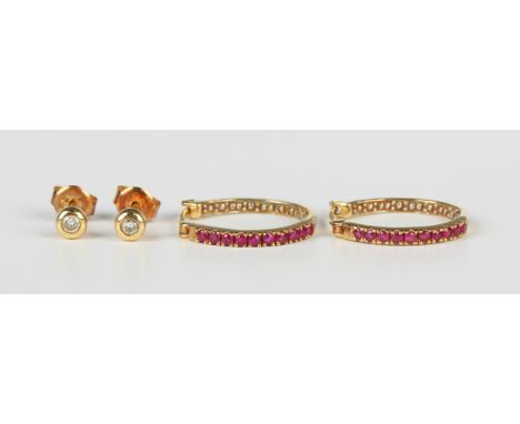 A pair of 9ct gold and ruby earrings in a hoop shaped design, with hinged post fittings, weight 2.2g, length 1.8cm, and a pai