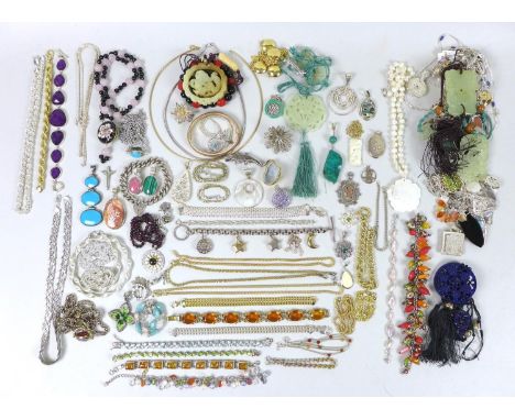 A quantity of costume jewellery, including a mother of pearl carved pendant, a number of jade carved pendants, a silver curb 