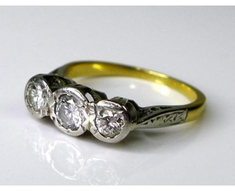 A three stone diamond ring, the central diamond of approximately 0.17ct, 3.5mm diameter, the two flanking diamonds each appro