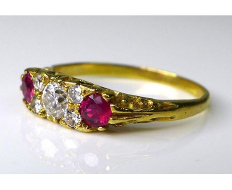 An 18ct gold, diamond and ruby ring, of Georgian style, the central brilliant cut diamond of approximately 0.2ct, flanked by 