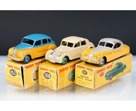 Three boxed Dinky diecast models to include 158 Riley Saloon in cream, 157 Jaguar XK120 Coupe in grey/yellow and 152 Austin D