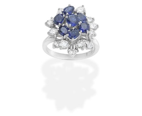 SAPPHIRE AND DIAMOND DRESS RING, 1976The oval-cut sapphires, within an undulating surround of brilliant-cut diamonds, mounted