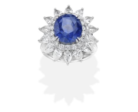 SAPPHIRE AND DIAMOND CLUSTER RINGSet with an oval-cut sapphire and brilliant and pear-shaped diamonds, diamonds approx. 4.25c