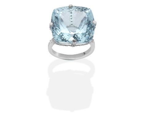 AQUAMARINE AND DIAMOND RINGCushion-shaped aquamarine, gallery accented by brilliant-cut diamonds, mounted in 18 carat gold, a