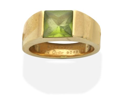 CARTIER: PERIDOT 'TANK' RINGSet with a fancy-cut peridot, mounted in 18 carat gold, signed Cartier, numbered, Swiss assay mar