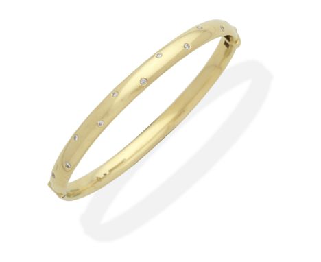DIAMOND-SET BANGLE, 2000Brilliant-cut diamonds set to the front of the hinged 18 carat gold bangle, UK hallmark, European con
