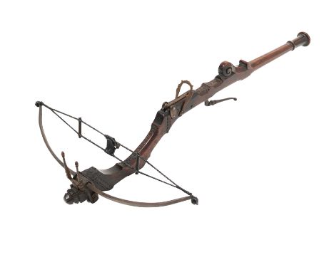AN ITALIAN STONEBOW, 17TH/18TH CENTURY  with slender steel bow retained by a pair of moulded irons, carved hardwood tiller of