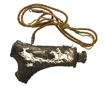 A SOUTH GERMAN (BLACK FOREST) POWDER FLASK, 19TH CENTURY of dark cameo-carved stag horn, the outer face decorated with a stag