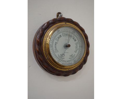 Early 20th century aneroid barometer mounted on carved oak by W. H. May Nottingham (D19cm), and a Rototherm Pat No. 378314 de